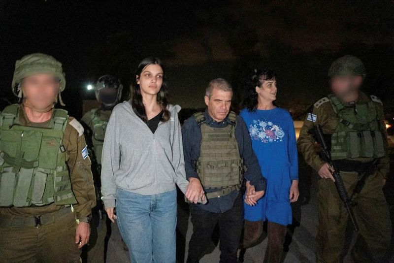 © Reuters. Judith Tai Raanan and her daughter Natalie Shoshana Raanan, U.S. citizens who were taken as hostages by Palestinian Hamas militants, walk while holding hands with Brig.-Gen. (Ret.) Gal Hirsch, Israel's Coordinator for the Captives and Missing, after they were released by the militants, in response to Qatari mediation efforts, in this handout picture obtained by Reuters on October 20, 2023.  Government of Israel/Handout via REUTERS THIS IMAGE HAS BEEN SUPPLIED BY A THIRD  PARTY.  FACES BLURRED AT SOURCE