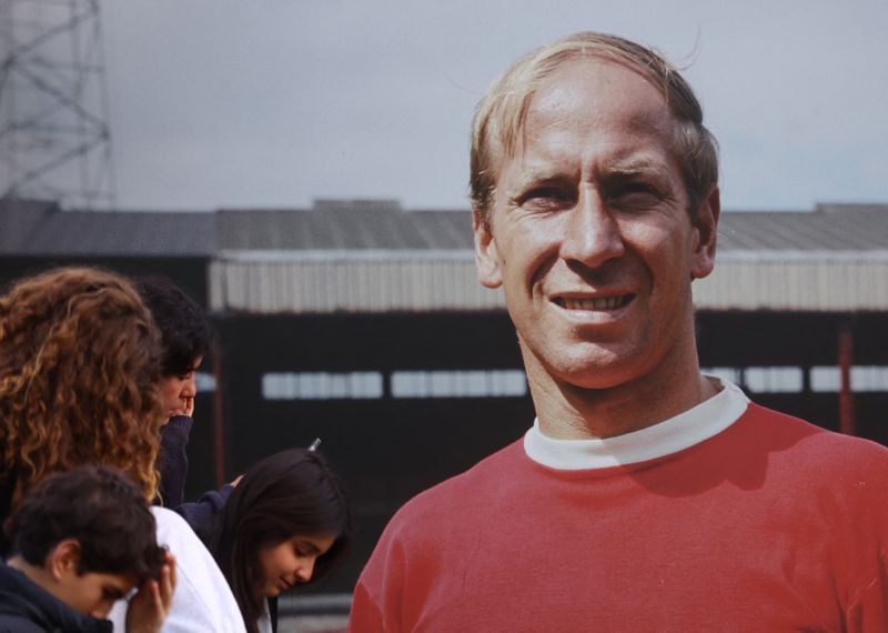 &copy; Reuters. Soccer Football  - Bobby Charlton Tributes - Old Trafford, Manchester, Britain - October 21, 2023 A picturer of Bobby Charlton is seen outside Old Trafford following his passing REUTERS/Carl Recine