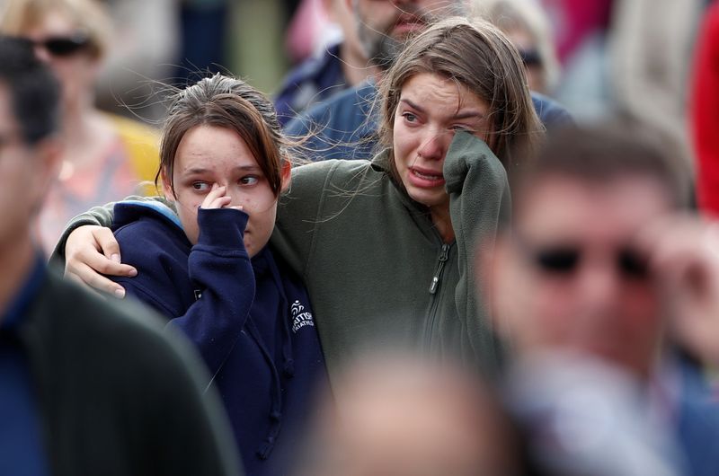 &copy; Reuters. Women react as the national anthem is played during the national remembrance service for victims of the mosque attacks, at Hagley Park in Christchurch, New Zealand March 29, 2019. REUTERS/Edgar Su/File Photo