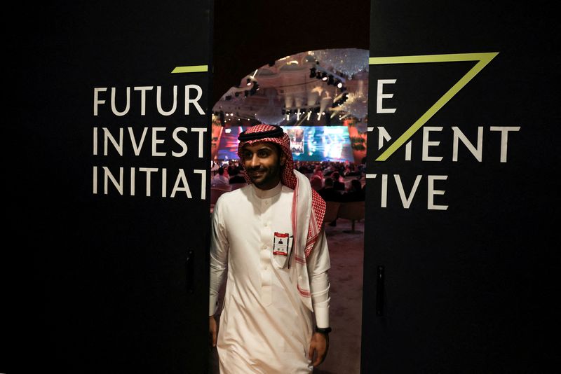 &copy; Reuters. FILE PHOTO: A Saudi man's reflection is seen in mirror glass at the Future Investment Initiative conference, in Riyadh, Saudi Arabia, October 25, 2022. REUTERS/ Ahmed Yosri/File Photo