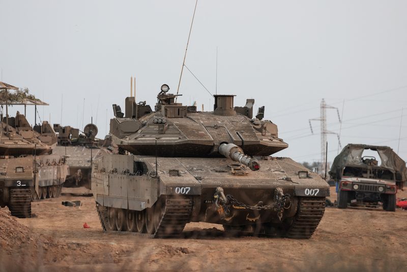 &copy; Reuters. FILE PHOTO: An Israeli tank and military vehicles are seen near Israel's border with the Gaza Strip, in southern Israel, October 22, 2023. REUTERS/Violeta Santos Moura/File photo