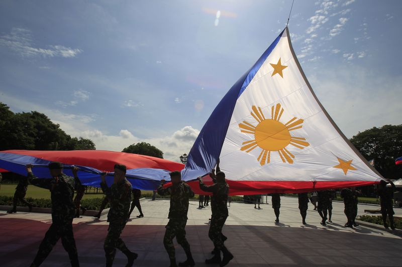 &copy; Reuters. Des soldats hissent le drapeau national des Philippines lors d'une répétition. /Photo prise le 11 juin 2014/REUTERS/Romeo Ranoco