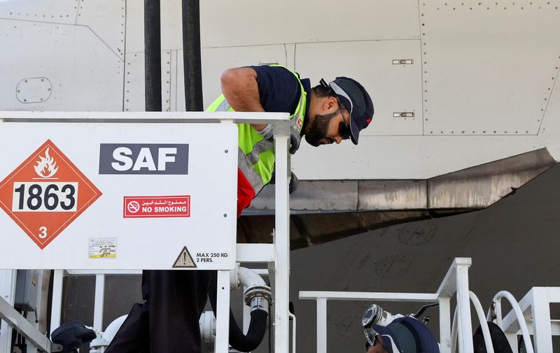 &copy; Reuters. FILE PHOTO: A staff is pictured as he fills up the Emirates Airlines Boeing 777-300ER with Sustainable Aviation Fuel (SAF), during a milestone demonstration flight while running one of its engines on 100% (SAF) at Dubai airport, in Dubai, United Arab Emir
