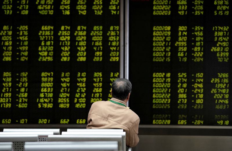 &copy; Reuters. FILE PHOTO: An investor watches a board showing stock information at a brokerage office in Beijing, China October 8, 2018. REUTERS/Jason Lee/File Photo