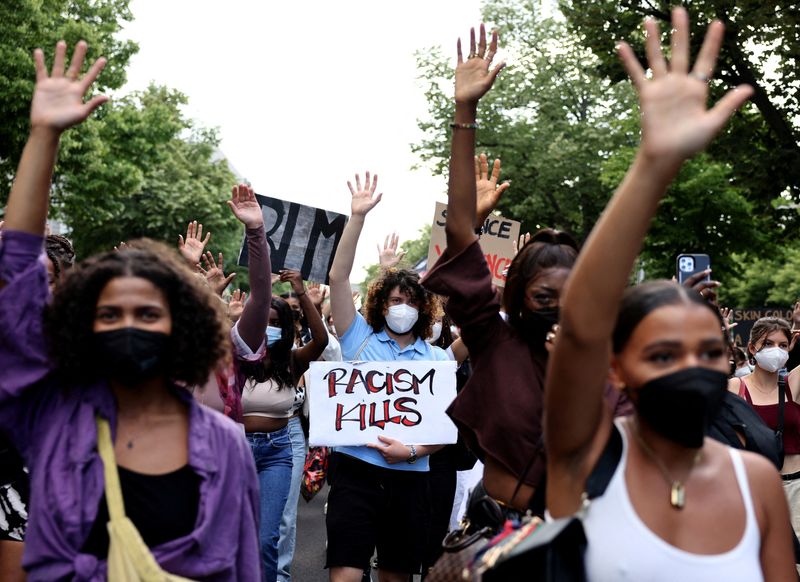 &copy; Reuters. FOTO DE ARCHIVO: Un manifestante sostiene una pancarta en la que se lee "El racismo mata" durante una protesta de Black Lives Matter en Berlín, Alemania. 2 de julio de 2021. REUTERS/Christian Mang