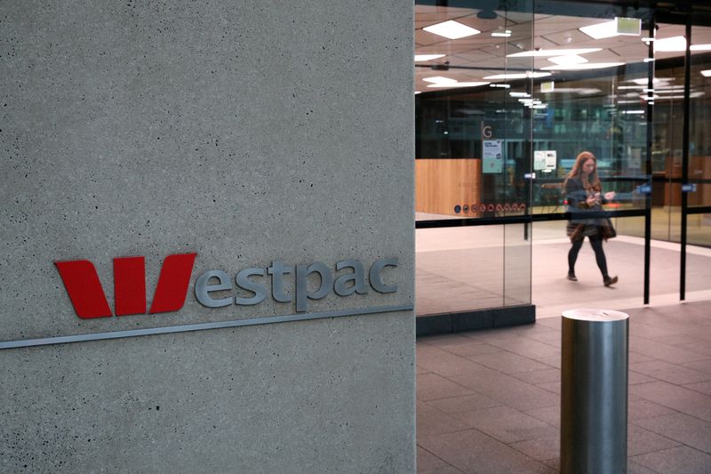 &copy; Reuters. FILE PHOTO: A woman exits the ground floor of an office building with Westpac logo amidst the easing of the coronavirus disease (COVID-19) restrictions in the Central Business District of Sydney, Australia, June 3, 2020. REUTERS/Loren Elliott/File Photo