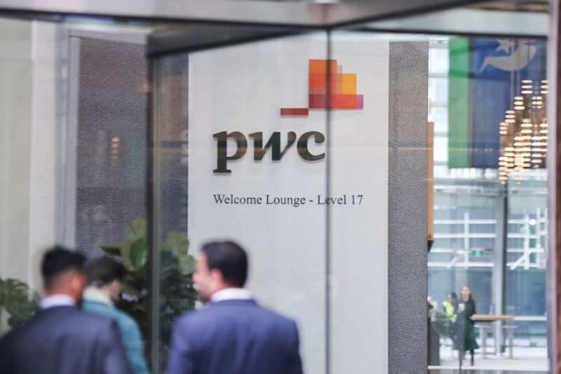 © Reuters. FILE PHOTO: PwC sign is seen in the lobby of their offices in Barangaroo, Australia June 22, 2023. REUTERS/Lewis Jackson