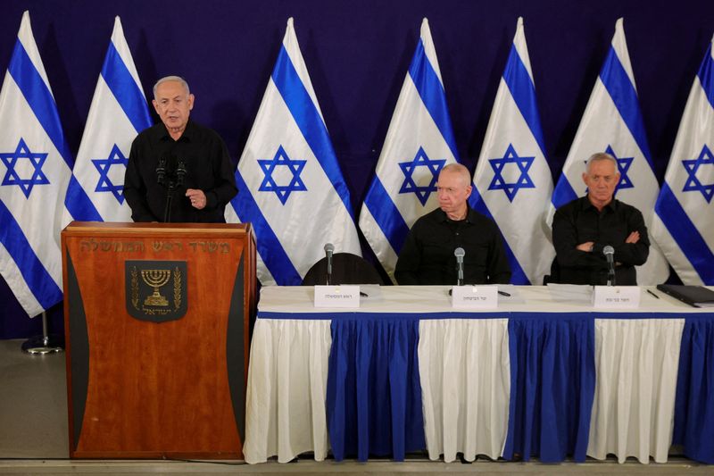 &copy; Reuters. El primer ministro israelí, Benjamin Netanyahu, con el ministro de Defensa, Yoav Gallant, y el ministro del Gabinete, Benny Gantz, habla durante una rueda de prensa en la base militar de Kirya en Tel Aviv, Israel, 28 de octubre de 2023. ABIR SULTAN POOL/