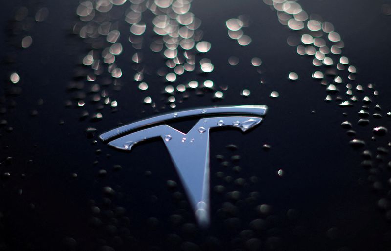 &copy; Reuters. FILE PHOTO: Raindrops are seen on the bonnet of a used Tesla electric car outside the showroom of a used car dealer in Manchester, Britain, October 19, 2023. REUTERS/Phil Noble/File Photo