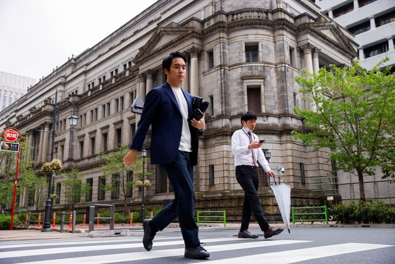 &copy; Reuters. People walk in front of the bank of Japan building in Tokyo, Japan, April 7, 2023. REUTERS/Androniki Christodoulou/ File photo