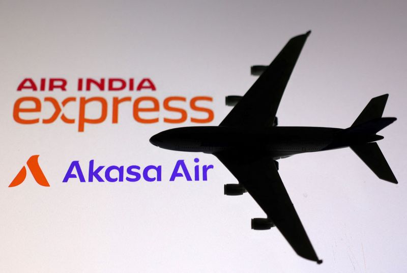 © Reuters. A miniature airplane is placed on the displayed Air India Express and Akasa Air logos, in this illustration taken October 30, 2023. REUTERS/Dado Ruvic/Illustration