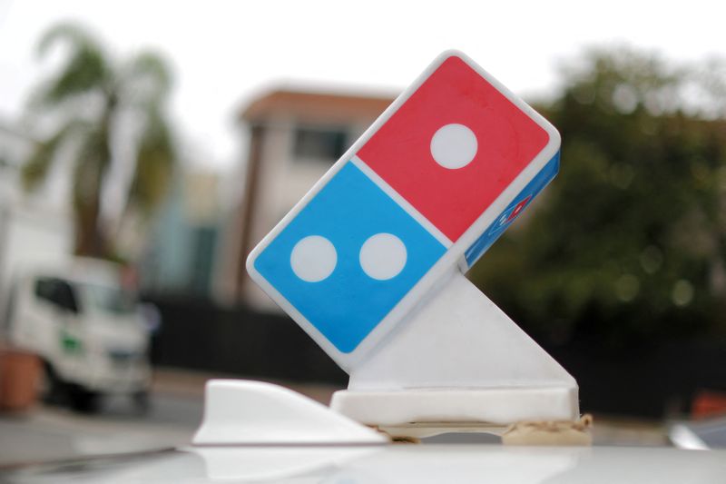 &copy; Reuters. FILE PHOTO: A Domino's Pizza sign sits on the top of a delivery car outside a restaurant in Los Angeles, California, U.S. July 18, 2018. REUTERS/Lucy Nicholson/File Photo