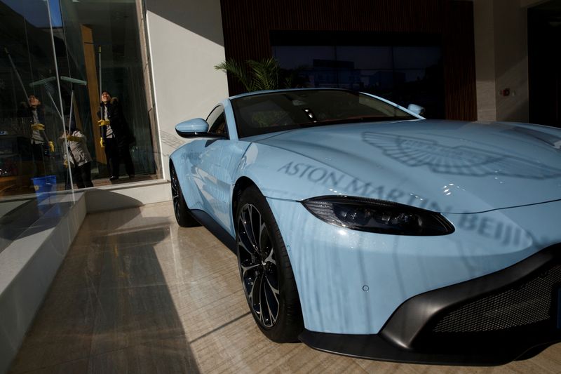 &copy; Reuters. FILE PHOTO: The shadow of the Aston Martin brand logo is cast onto the bonnet of a luxury sports car at a dealership in Beijing, China, December 12, 2018.  REUTERS/Thomas Peter/File Photo