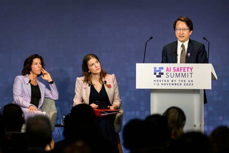 © Reuters. U.S. Secretary of Commerce Gina Raimondo and British Secretary of State for Science, Innovation and Technology Michelle Donelan listen to China's Vice Minister of Science and Technology Wu Zhaohui speaking on Day 1 of the AI Safety Summit at Bletchley Park in Bletchley, Britain on November 1, 2023. The UK Government are hosting the AI Safety Summit bringing together international governments, leading AI companies, civil society groups and experts in research to consider the risks of AI, especially at the frontier of development, and discuss how they can be mitigated through internationally coordinated action.     Leon Neal/Pool via REUTERS