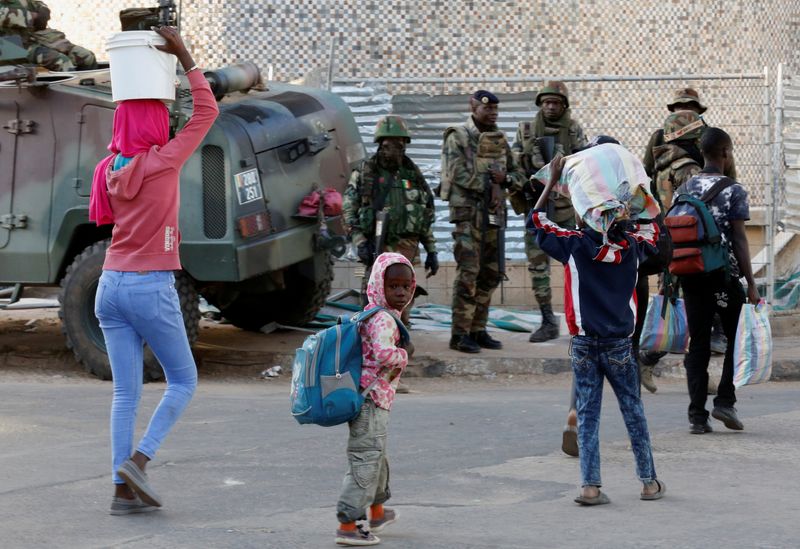 &copy; Reuters. Children walk past regional ECOWAS troops in Banjul, Gambia January 23, 2017. REUTERS/Thierry Gouegnon/File Photo