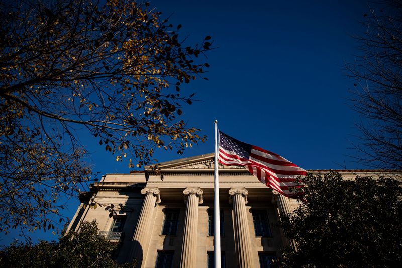&copy; Reuters. An American flag waves outside the U.S. Department of Justice Building in Washington, U.S., December 15, 2020. REUTERS/Al Drago/File Photo