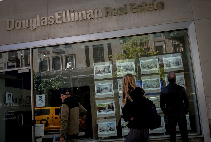&copy; Reuters. FILE PHOTO: A man looks at advertisements for luxury apartments and homes in the window of a Douglas Elliman Real Estate sales business in Manhattan's upper east side neighborhood in New York City, New York, U.S. October 19, 2021. REUTERS/Mike Segar/File 