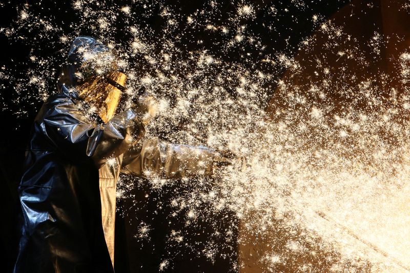 &copy; Reuters. A steel worker of ThyssenKrupp stands amid sparks of raw iron coming from a blast furnace at a ThyssenKrupp steel factory in Duisburg, western Germany, November 14, 2022. REUTERS/Wolfgang Rattay/File Photo