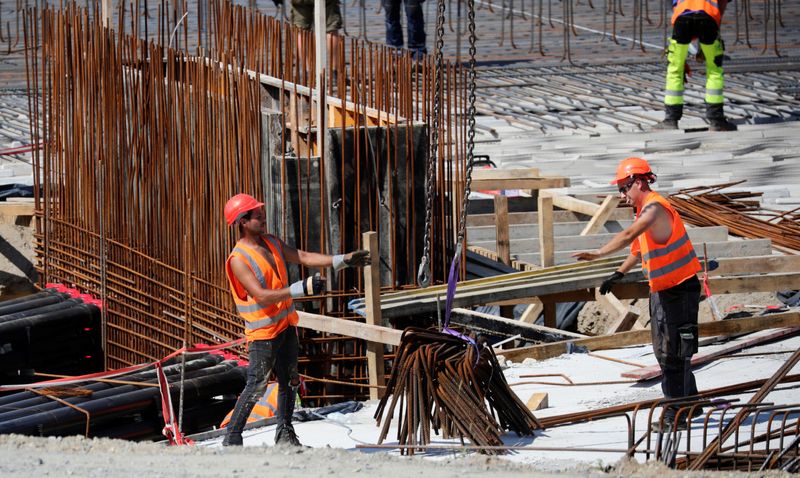 &copy; Reuters. People work at the construction site of the future Tesla Gigafactory in Gruenheide near Berlin, Germany, August 12, 2021. REUTERS/Hannibal Hanschke/File Photo