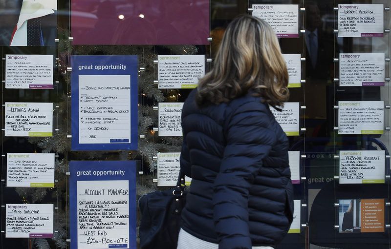 &copy; Reuters. A woman passes a recruitment centre in London December 14, 2011. REUTERS/Luke MacGregor/File photo