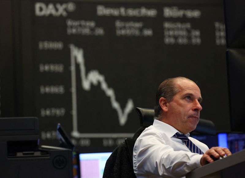 © Reuters. FILE PHOTO: A stock broker sits in front of the share price index DAX graph following the shares of Credit Suisse hit a record low in a rout of European bank stocks, as investor concerns about sector stresses triggered by Silicon Valley Bank's implosion deepened, at the stock exchange in Frankfurt, Germany, March 16, 2023. REUTERS/Kai Pfaffenbach