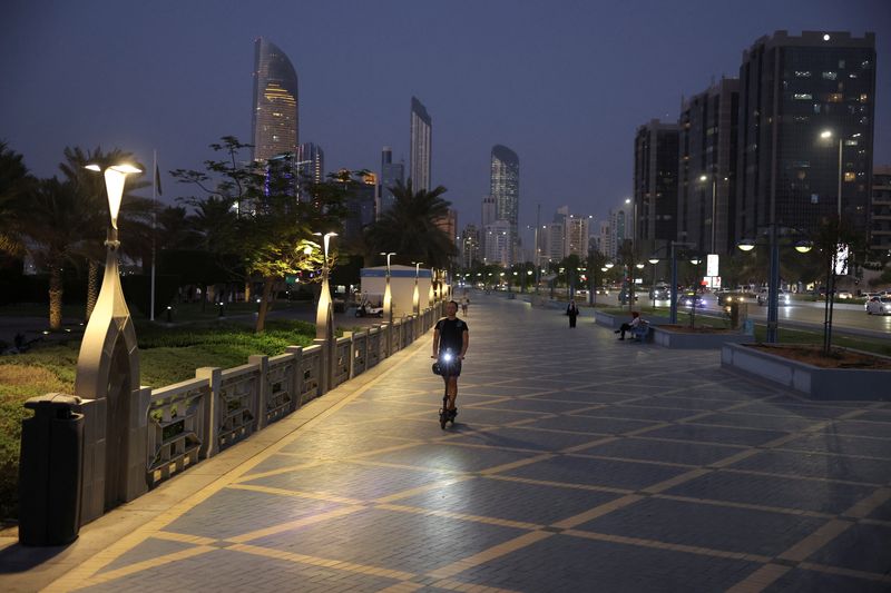 &copy; Reuters. FILE PHOTO: A person rides a scooter with the skyline visible in the background, in Abu Dhabi, United Arab Emirates, September 27, 2023. REUTERS/Amr Alfiky/File Photo