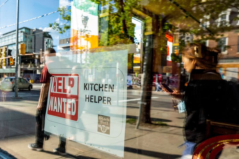 &copy; Reuters. A help wanted sign hangs in a bar window along Queen Street West in Toronto Ontario, Canada June 10, 2022. REUTERS/Carlos Osorio