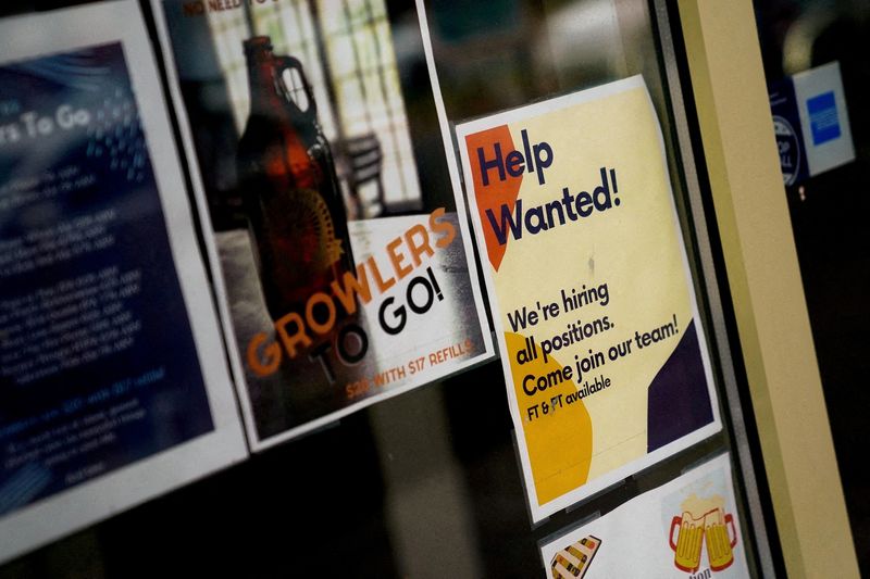 &copy; Reuters. FILE PHOTO: An employee hiring sign is seen in a window of a business in Arlington, Virginia, U.S., April 7, 2023. REUTERS/Elizabeth Frantz/File Photo