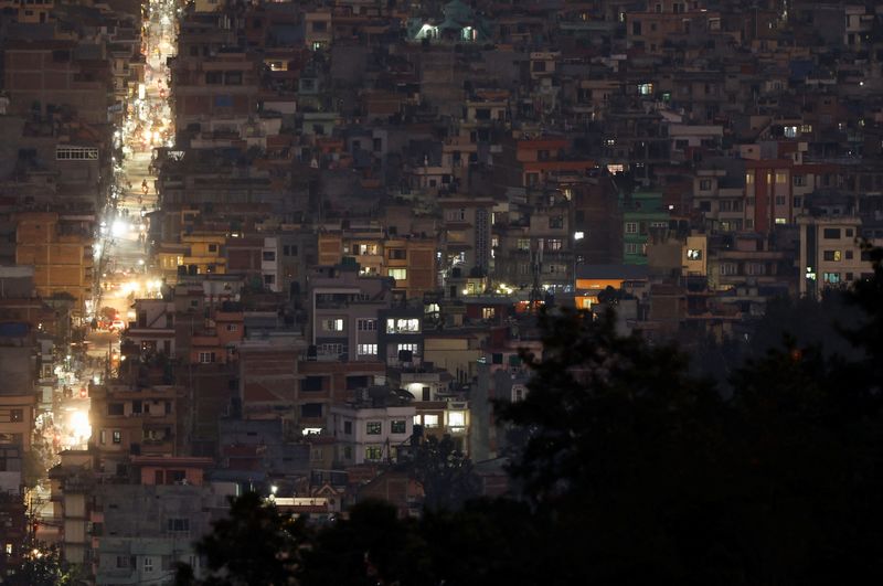 &copy; Reuters. FILE PHOTO: Light illuminates a street between the cluster of residential buildings in Kathmandu, Nepal November 8, 2022. REUTERS/Navesh Chitrakar/File Photo