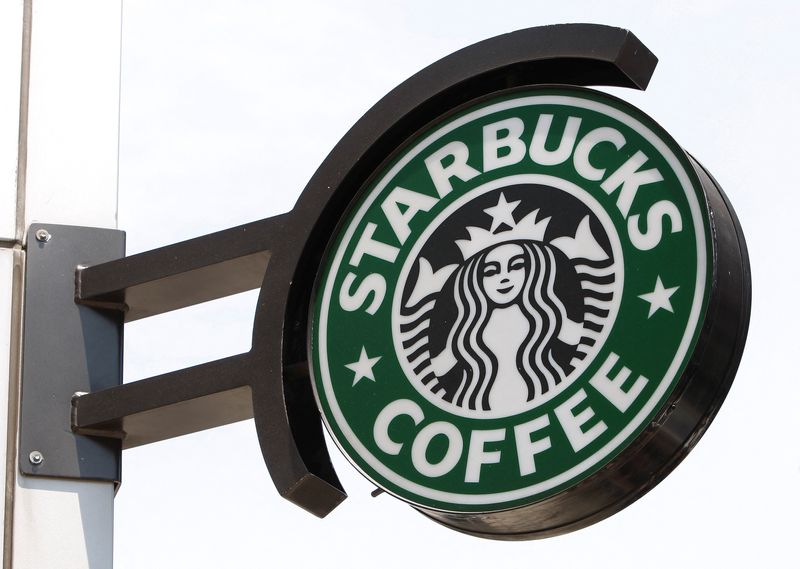 © Reuters. FILE PHOTO: The Starbucks sign is seen outside one of its stores in New York July 3, 2008. REUTERS/Chip East (UNITED STATES)/File Photo