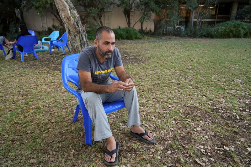© Reuters. Avihai Brodutch, whose wife and three children were abducted by Hamas militants on October 7 from their home in Kibbutz Kfar Aza, is photographed during an interview with Reuters from his temporary lodging at a resort in Kibbutz Shefayim, Israel, November 6, 2023. REUTERS/Joseph Campbell