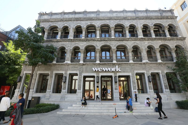 &copy; Reuters. People are seen outside the building of Wework's co-working space during the National Day Golden Week holiday, in central Beijing, China October 2, 2018. Picture taken October 2, 2018. REUTERS/Stringer/File Photo