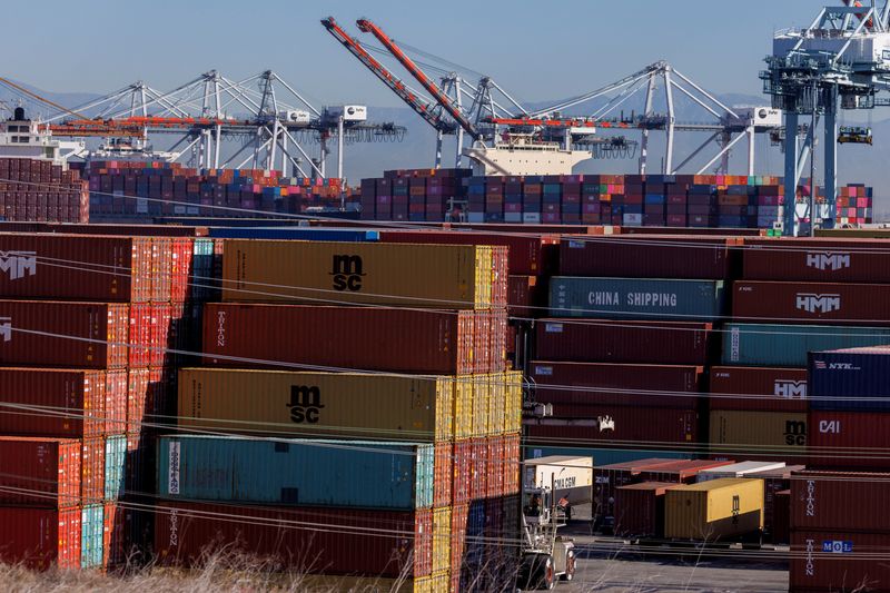 &copy; Reuters. FILE PHOTO: Stacked containers are shown as ships unload their cargo at the Port of Los Angeles in Los Angeles, California, U.S. November 22, 2021. REUTERS/Mike Blake/File Photo