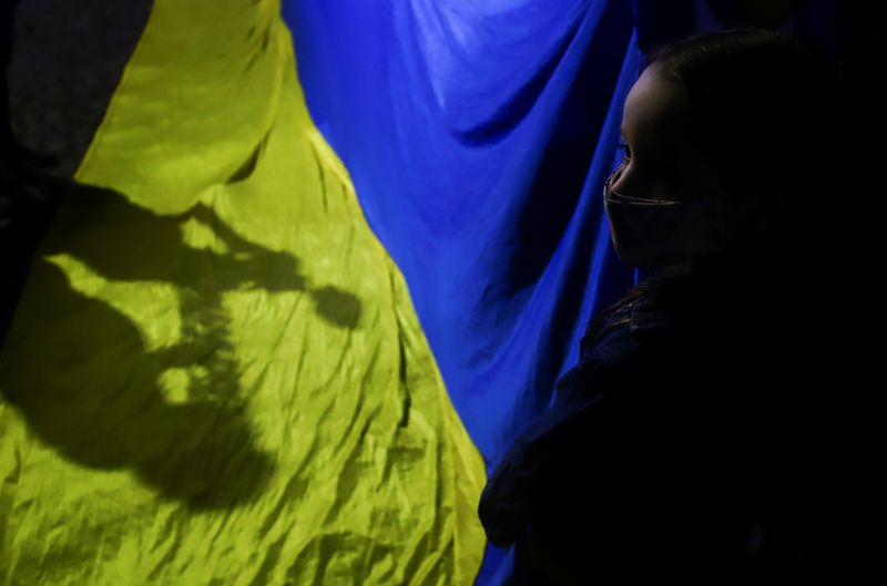 &copy; Reuters. A girl holds a Ukraine's flag during a protest against the massive military operation by Russia against Ukraine, in front of the Ukrainian Embassy in Buenos Aires, Argentina February 24, 2022. REUTERS/Matias Baglietto/File Photo