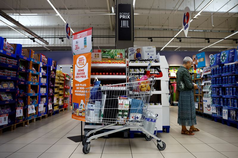 &copy; Reuters. FILE PHOTO: A customer shops next to a sign reading "Anti-inflation challenge, third price cut" at a Carrefour supermarket in Montesson near Paris, France, September 13, 2023. REUTERS/Sarah Meyssonnier/File Photo