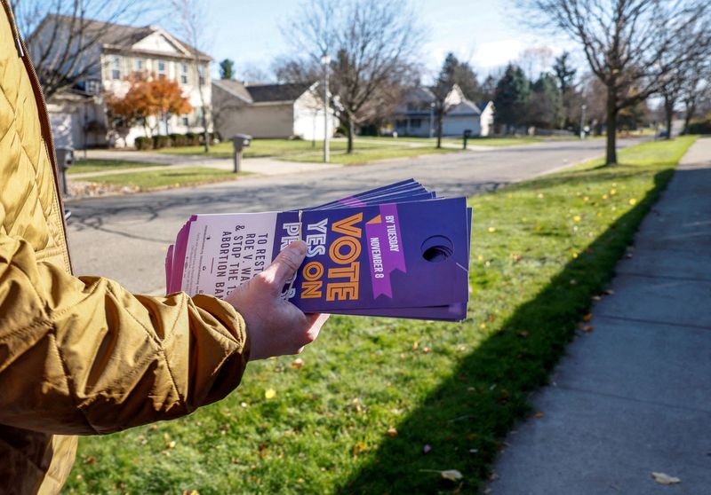 &copy; Reuters. FILE PHOTO: Nickolas Lentz, a volunteer with Reproductive Freedom for All, canvasses a neighborhood in support of Proposal 3, a ballot measure that would codify the right to an abortion, one day before the midterm election in Dewitt, Michigan, U.S., Novem