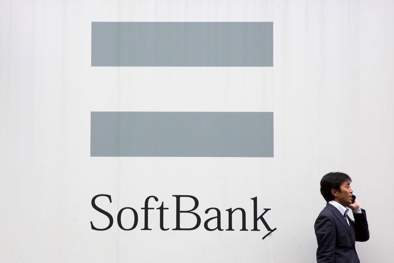 &copy; Reuters. A man talks on the phone as he stand in front of an advertising poster of the SoftBank telecommunications company in Tokyo October 16, 2015. REUTERS/Thomas Peter/File Photo