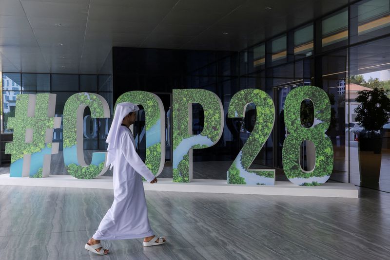 &copy; Reuters. FILE PHOTO: A person walks past a "#COP28" sign during The Changemaker Majlis, a one-day CEO-level thought leadership workshop focused on climate action, in Abu Dhabi, United Arab Emirates, October 1, 2023. REUTERS/Amr Alfiky/File Photo