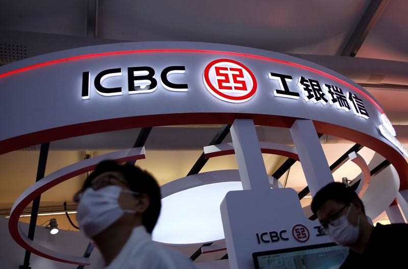 &copy; Reuters. FILE PHOTO: People walk past a booth of ICBC Credit Suisse Asset Management Co at the 2020 China International Fair for Trade in Services (CIFTIS), in Beijing, China September 5, 2020. REUTERS/Tingshu Wang/File photo