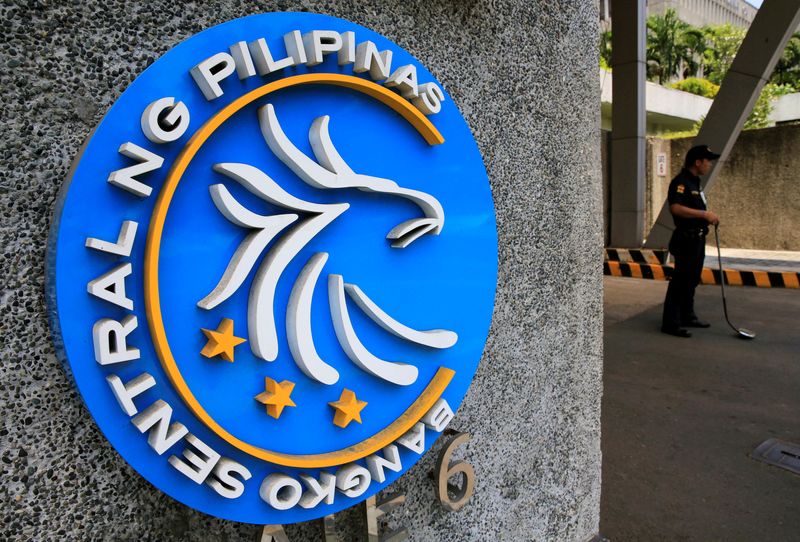 &copy; Reuters. FILE PHOTO: A security guard stands beside a logo of the Bangko Sentral ng Pilipinas (Central Bank of the Philippines) posted at the main gate in Manila, Philippines April 28, 2016. REUTERS/Romeo Ranoco/File Photo