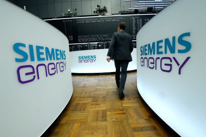 &copy; Reuters. A trader walks next to Siemens Energy AG logos during Siemens Energy's initial public offering (IPO) at the Frankfurt Stock Exchange in Frankfurt, Germany, September 28, 2020.     REUTERS/Ralph Orlowski/File Photo