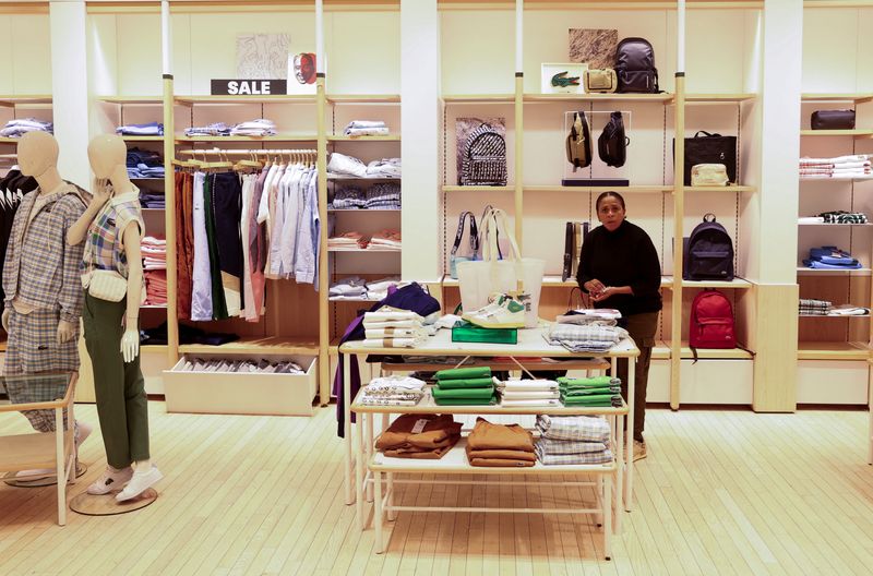 &copy; Reuters. FILE PHOTO: An employee sorts out clothing at a store of the French fashion brand Lacoste, in Sandton, near Johannesburg, South Africa, July 27, 2023. REUTERS/Siphiwe Sibeko/File Photo