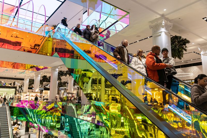 &copy; Reuters. FILE PHOTO: People ride escalator at Saks Fifth Avenue in New York City, U.S., December 4, 2022.  REUTERS/Jeenah Moon