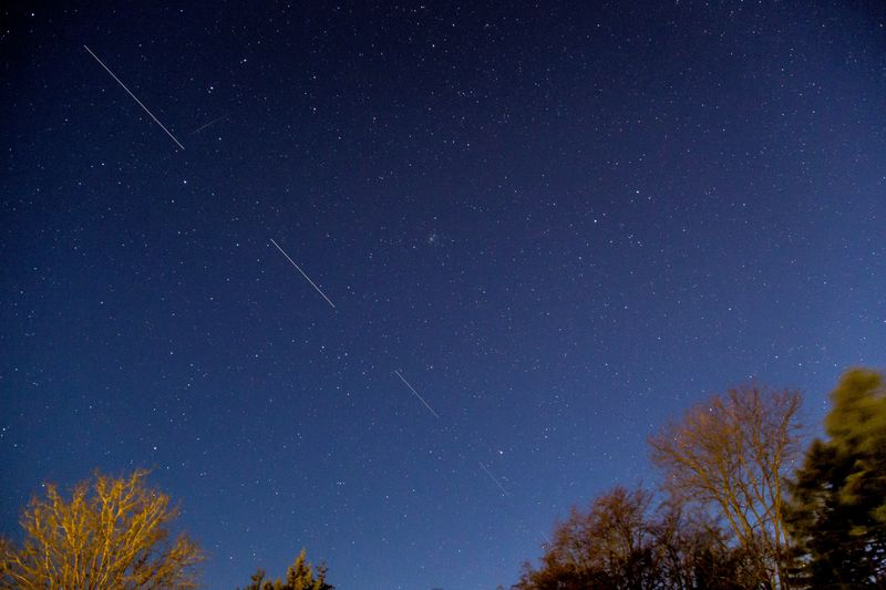 © Reuters. FILE PHOTO: SpaceX Starlink 5 satellites are pictured in the sky seen from Svendborg on South Funen, Denmark April 21, 2020. Picture taken with long exposure. Ritzau Scanpix/Mads Claus Rasmussen via REUTERS