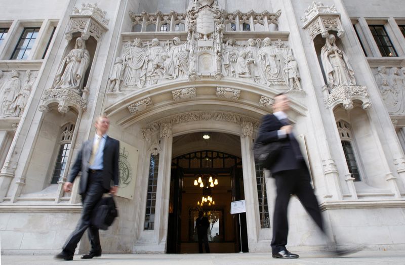 &copy; Reuters. FILE PHOTO: People walk out of the Supreme Court building in Westminster, central London September 14, 2009.    REUTERS/Andrew Winning/File Photo