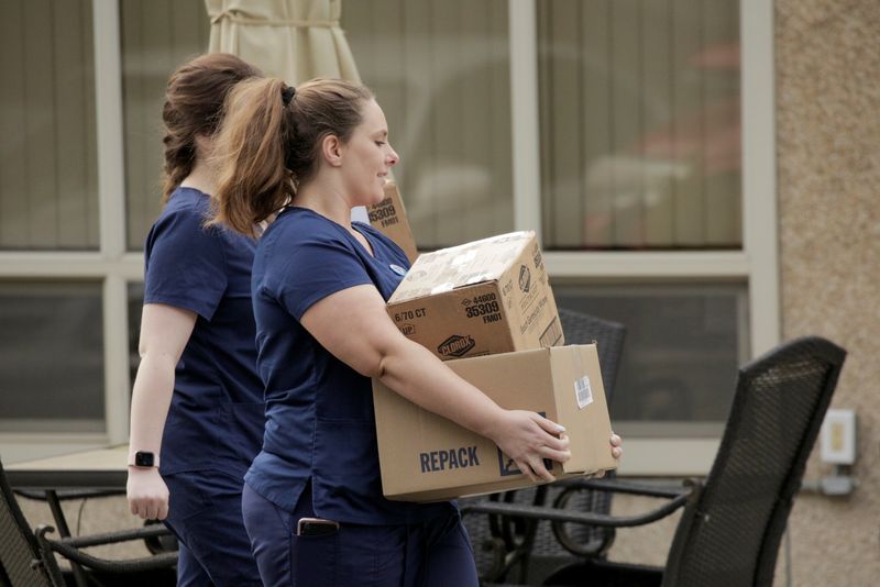 &copy; Reuters. Healthcare workers carry Clorox wipes and other supplies into the Life Care Center of Kirkland, the long-term care facility linked to several confirmed coronavirus cases in the state, in Kirkland, Washington, U.S. March 5, 2020.  REUTERS/David Ryder/File 