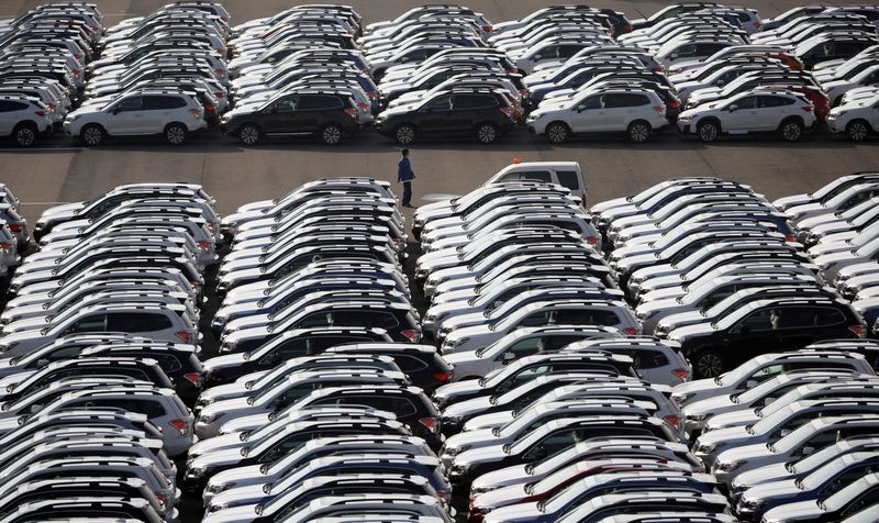 &copy; Reuters. FILE PHOTO: A worker is seen among newly manufactured cars awaiting export at port in Yokohama, Japan, November 15, 2017. REUTERS/Toru Hanai/File Photo