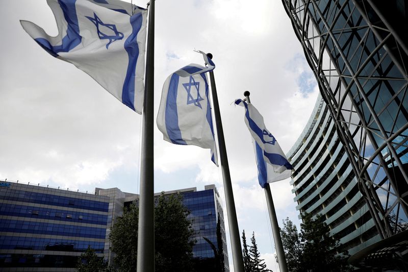 &copy; Reuters. FILE PHOTO: Israeli national flags flutter near office towers at a business park also housing high tech companies, at Ofer Park in Petah Tikva, Israel August 27, 2020. REUTERS/Ronen Zvulun/File Photo
