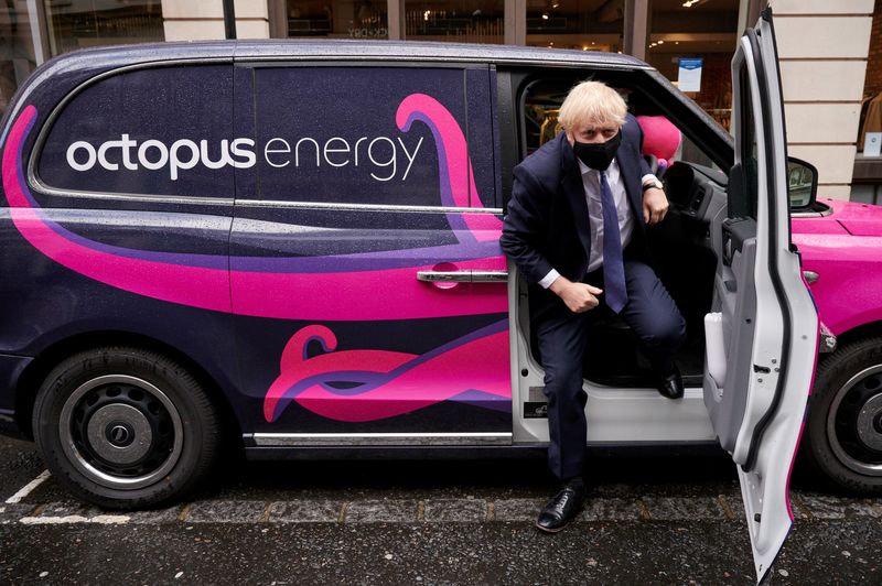 &copy; Reuters. FILE PHOTO: Britain's Prime Minister Boris Johnson poses for photographs with a branded electric taxi as he visits the headquarters of Octopus Energy, in London, Britain October 5, 2020. Leon Neal/Pool via REUTERS/File Photo