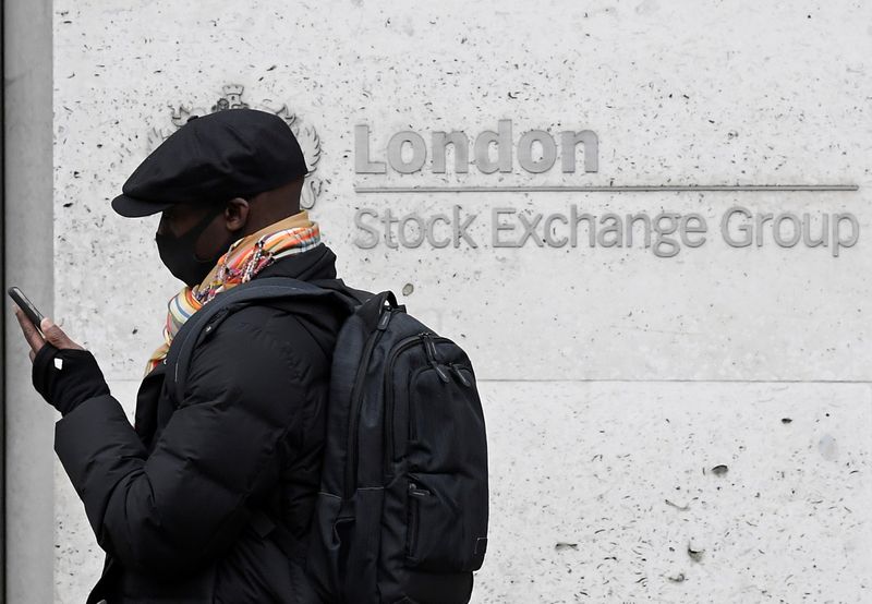 &copy; Reuters. A man wearing a protective face mask walks past the London Stock Exchange Group building in the City of London financial district, whilst British stocks tumble as investors fear that the coronavirus outbreak could stall the global economy, in London, Brit